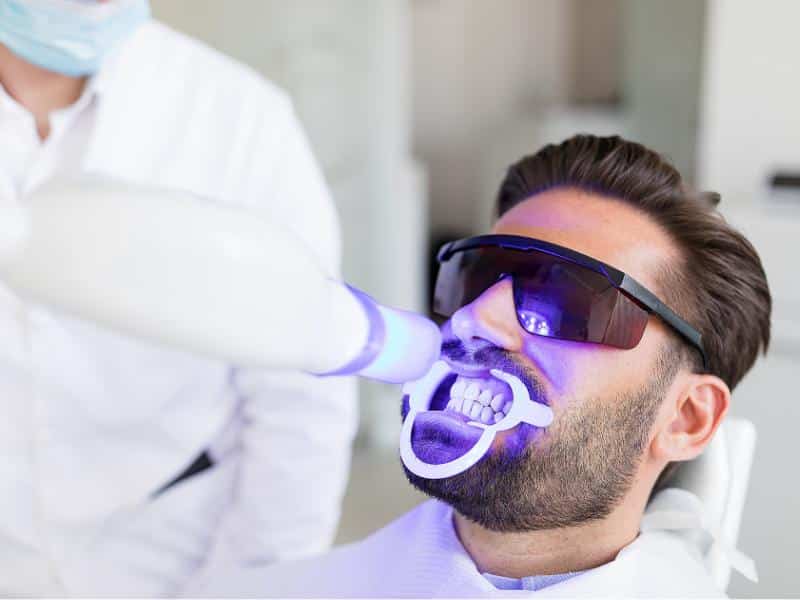 A patient undergoing teeth whitening in Burleson, TX